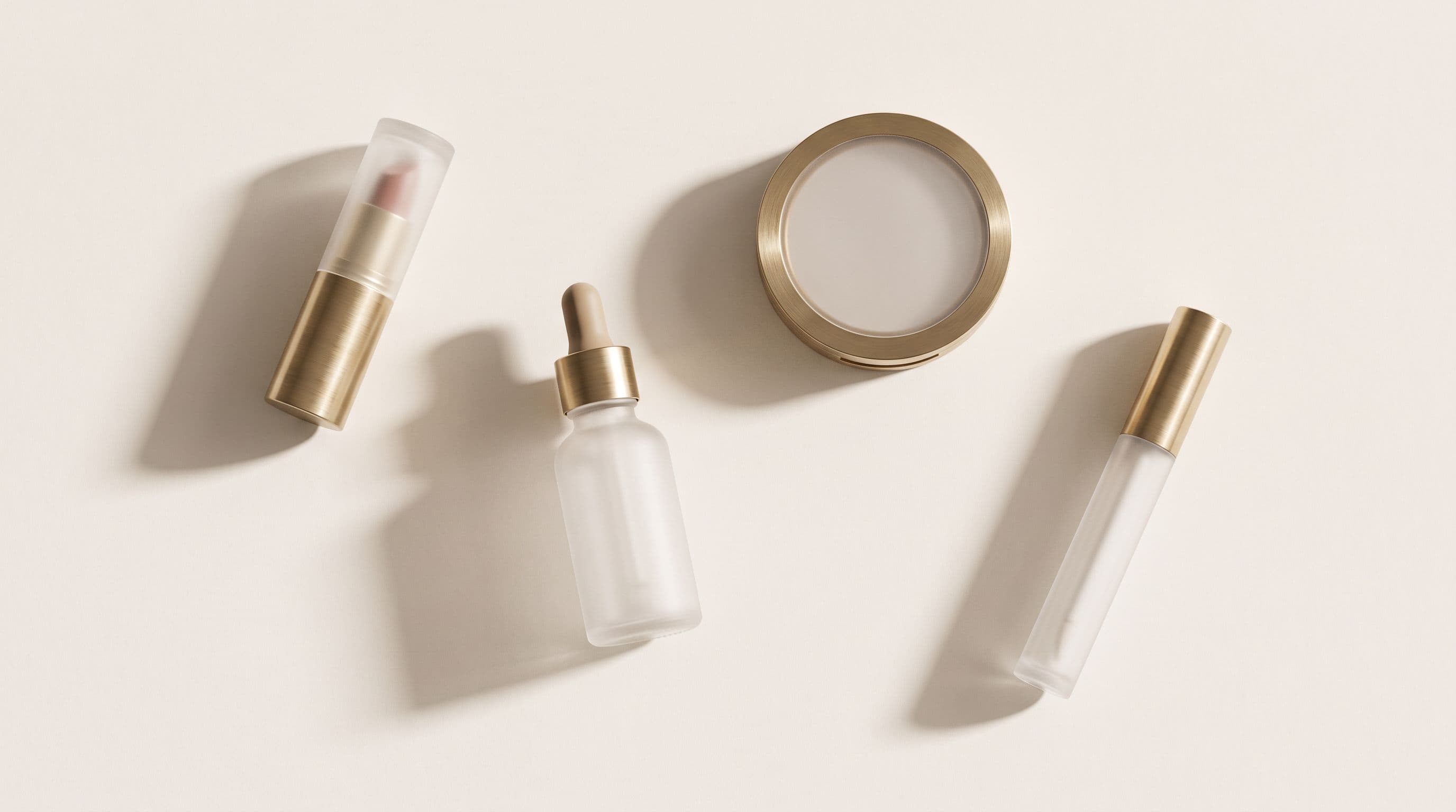 An overhead arrangement of Mirevoir pieces in frosted glass and brushed brass.